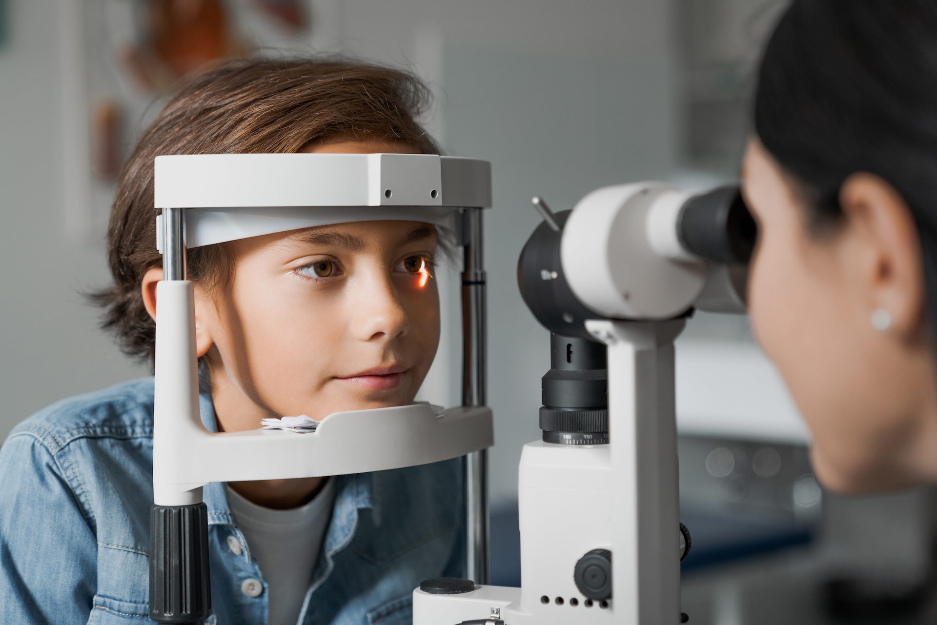 image of a doctor examining a child's eyes